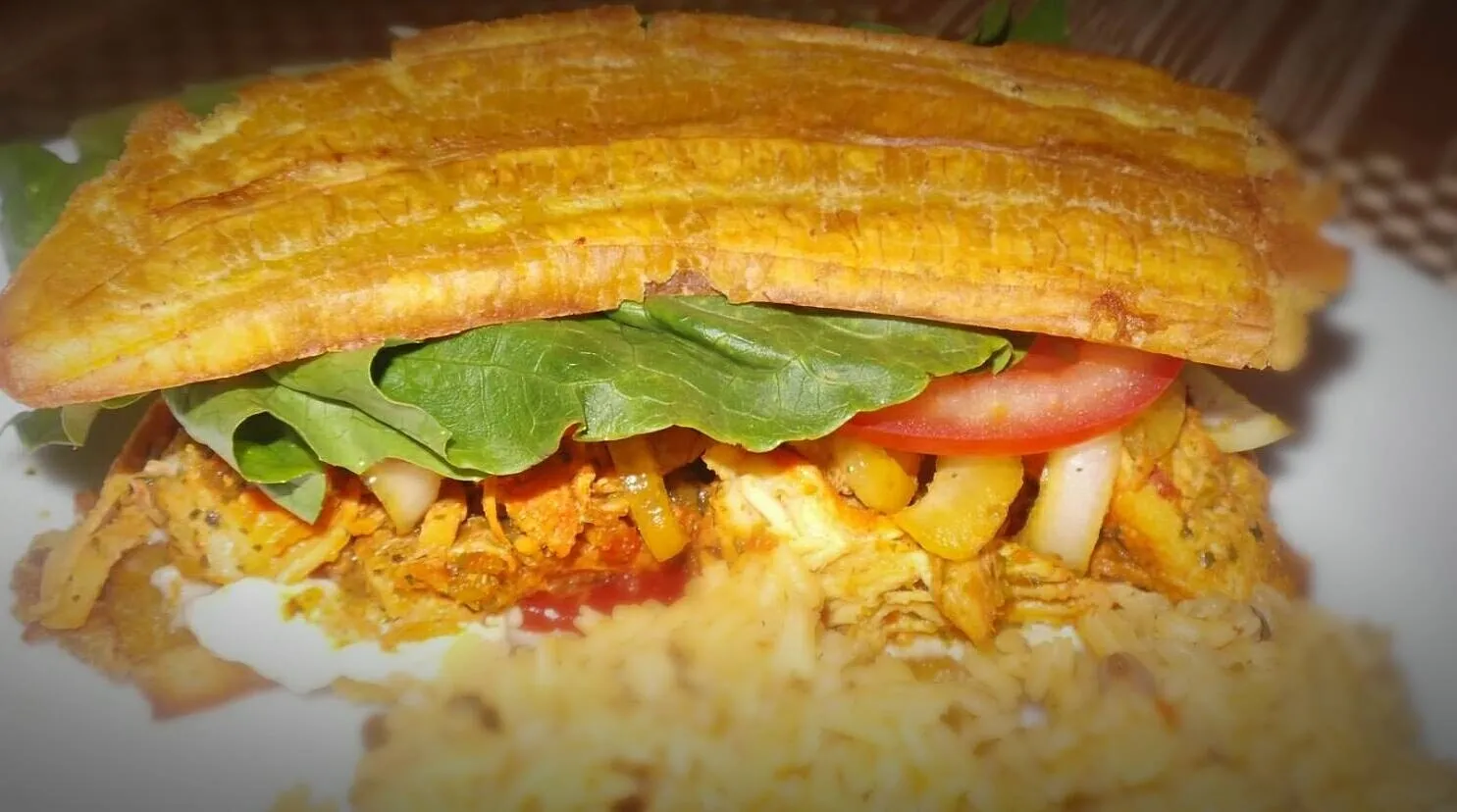 A close up of the sandwich with rice and vegetables