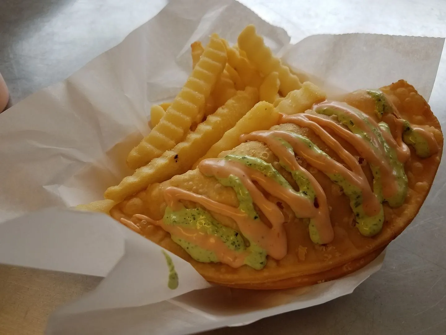 A basket of food with some fries on it