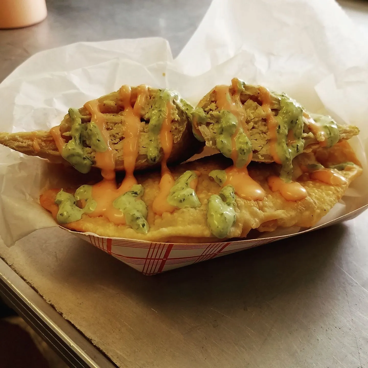 A basket of food with some kind of sauce on it