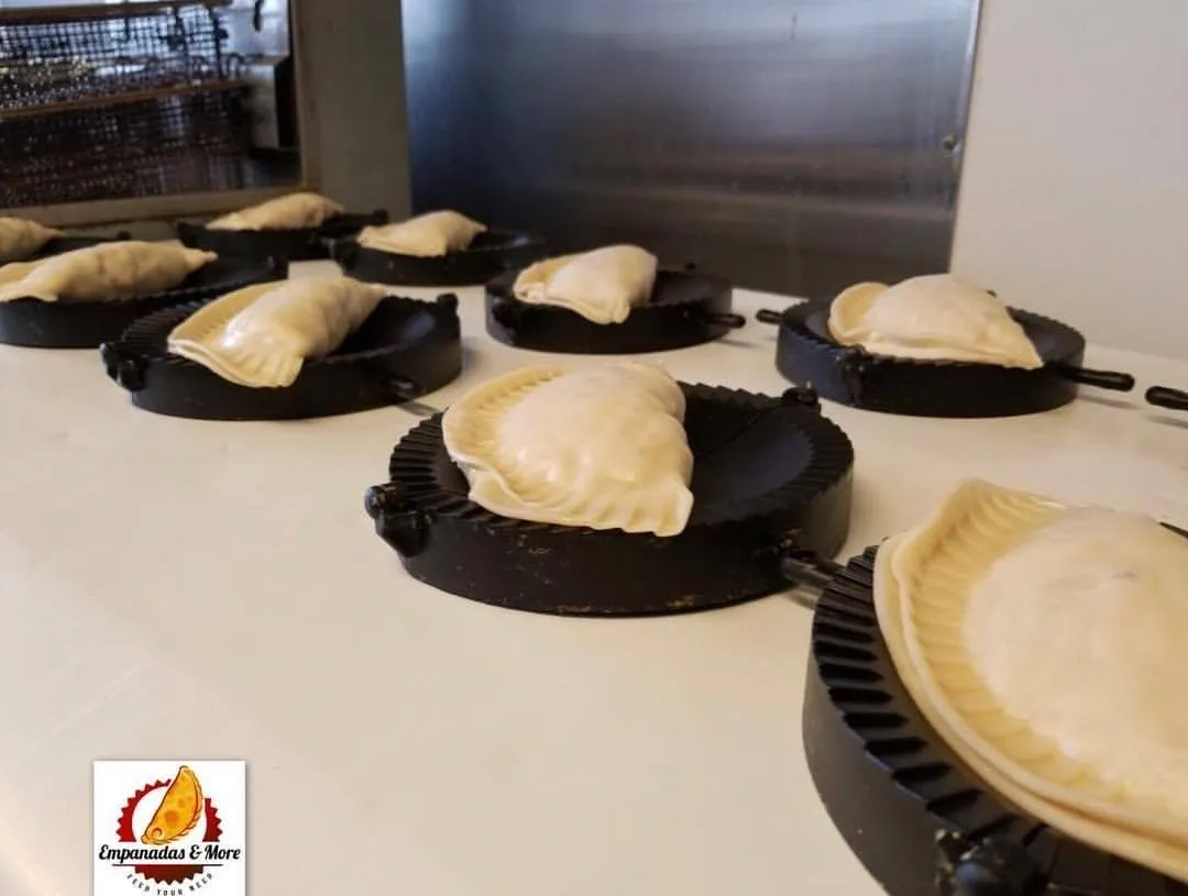 A table with several pies in pans on it.