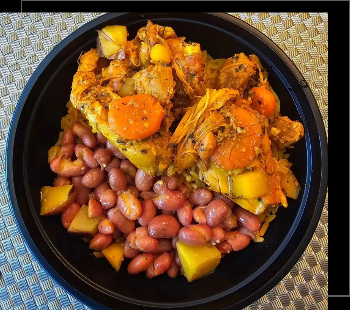 A black plate of food with beans and meat.