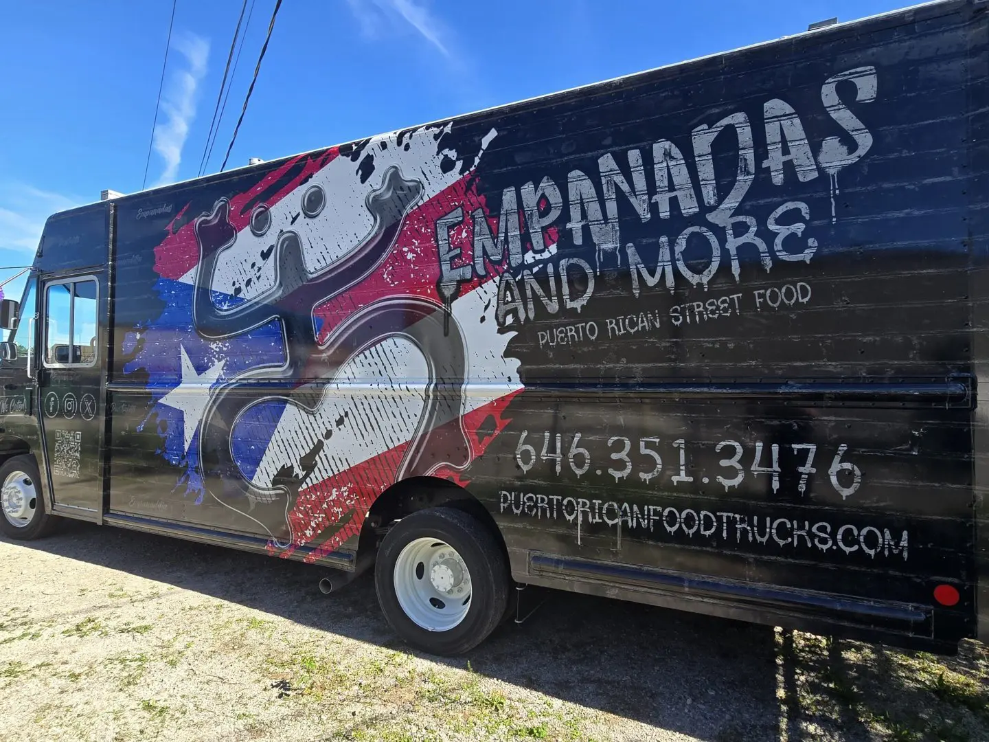 A large truck with graffiti on it parked in the street.